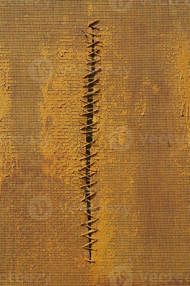 Yellow net. Wired hole. Texture of yellow surface. photo