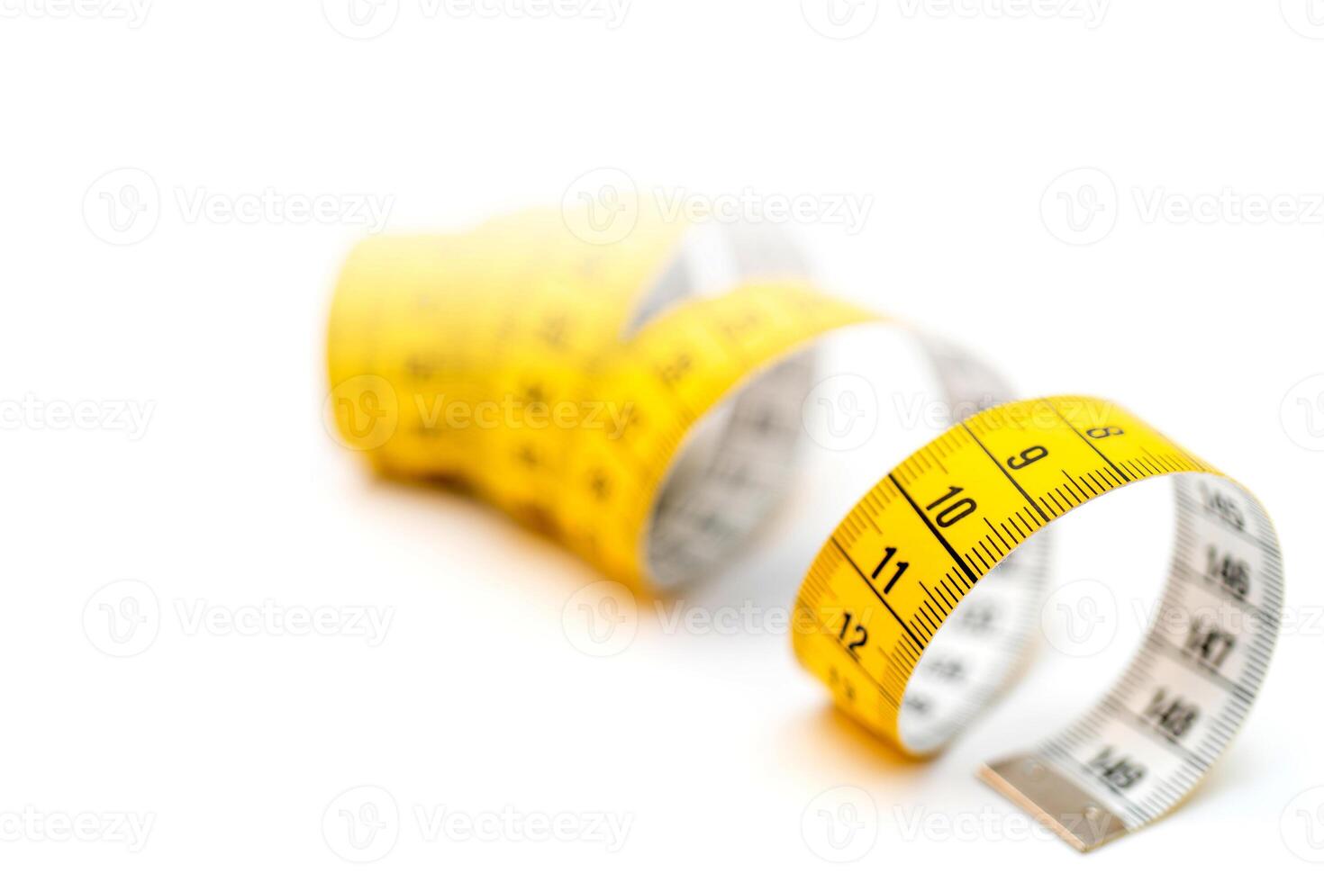 Yellow measuring tape on white background. Measurement of length and circumference. Lose weight and get fat. photo