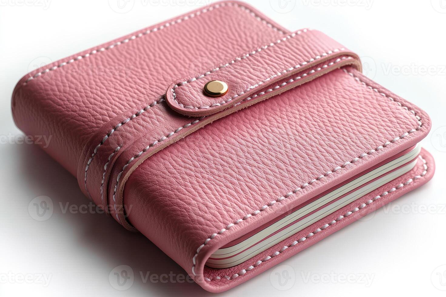 Pink leather notebook closed with a strap on white background photo