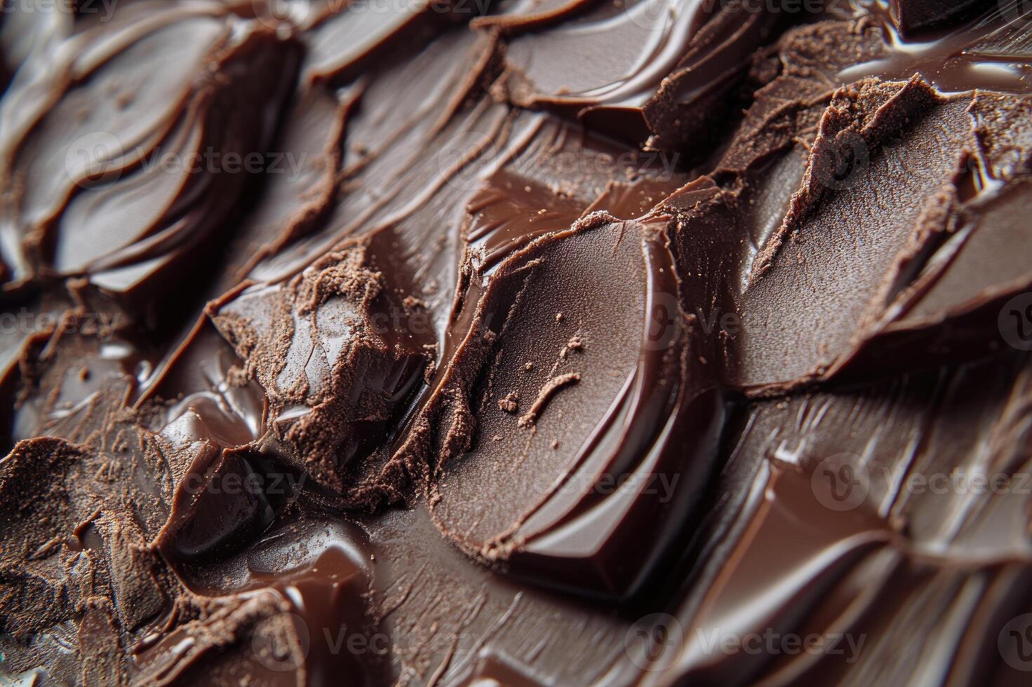 Melted dark chocolate swirls covering chocolate chunks background photo