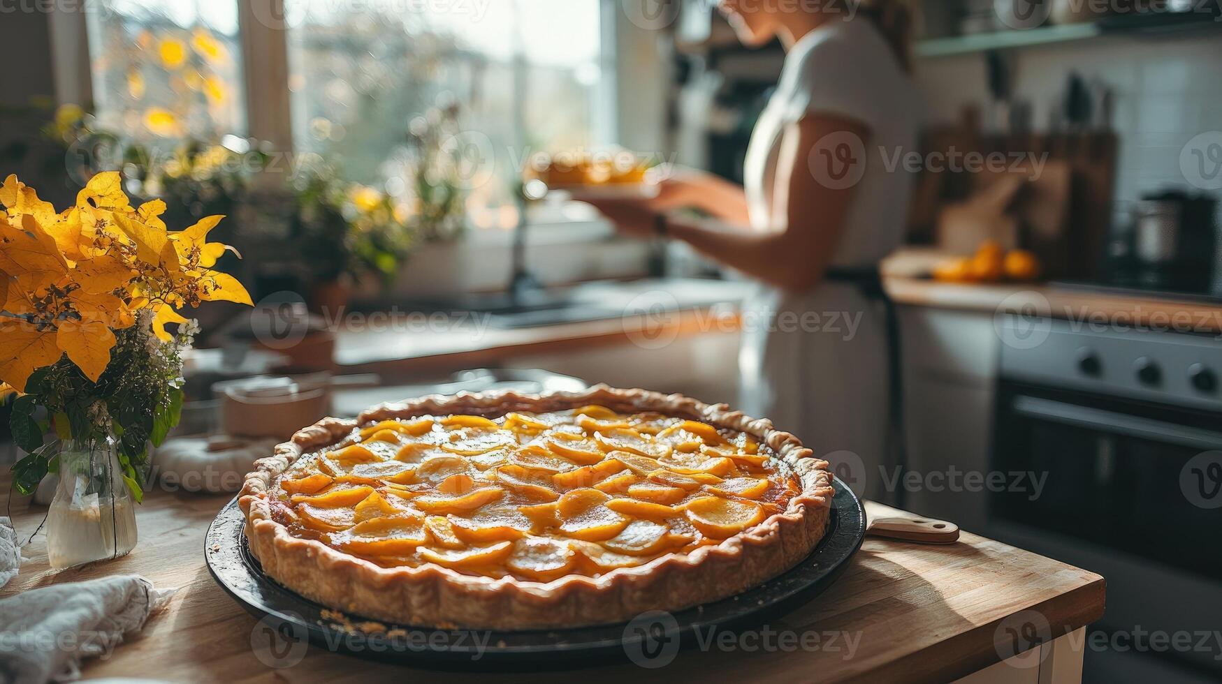 Freshly baked peach pie cooling on kitchen counter with baker in background photo
