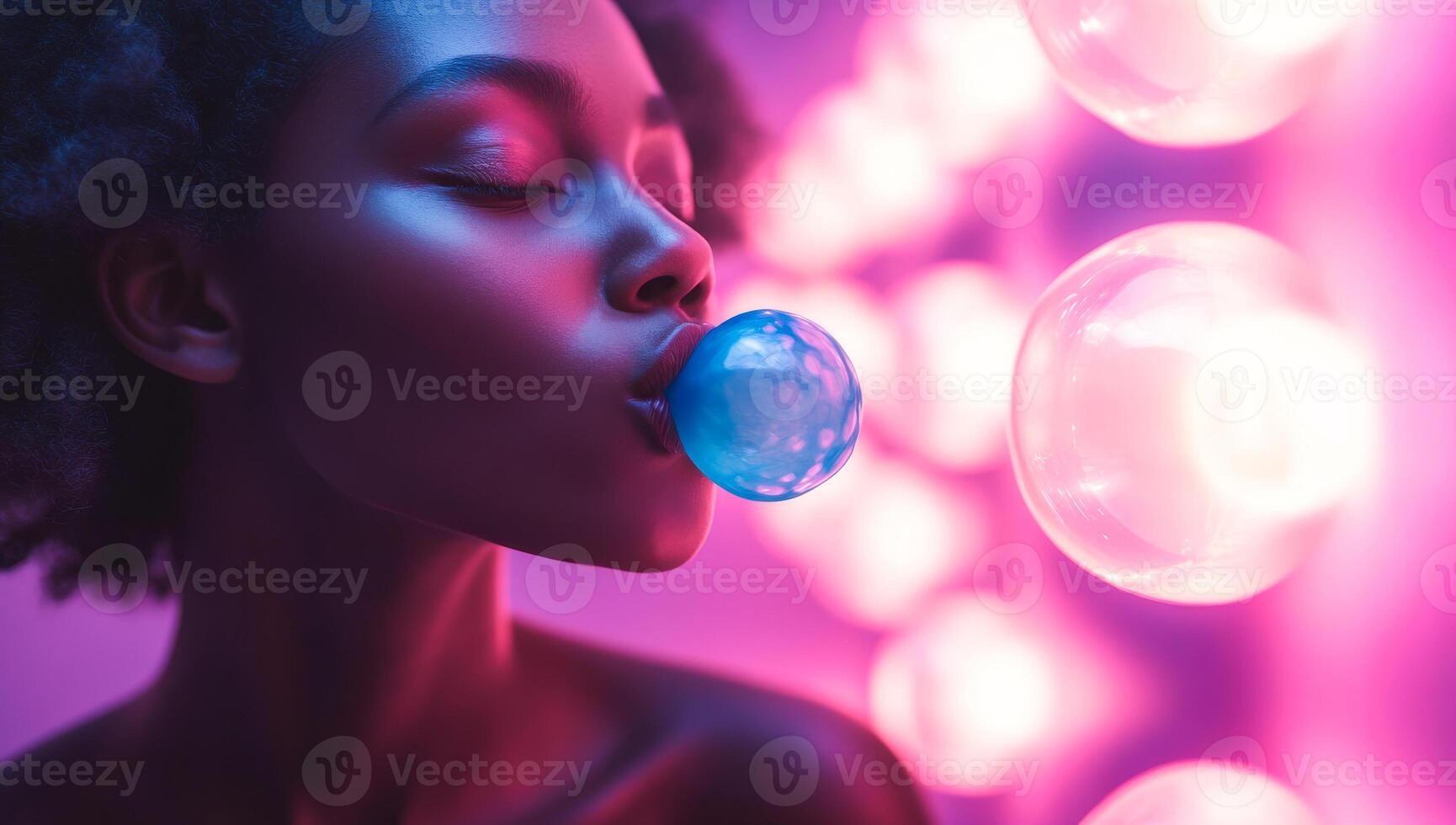 A woman is blowing bubbles with a blue bubblegum. The image has a fun and playful mood, as the woman is enjoying herself while blowing bubbles photo
