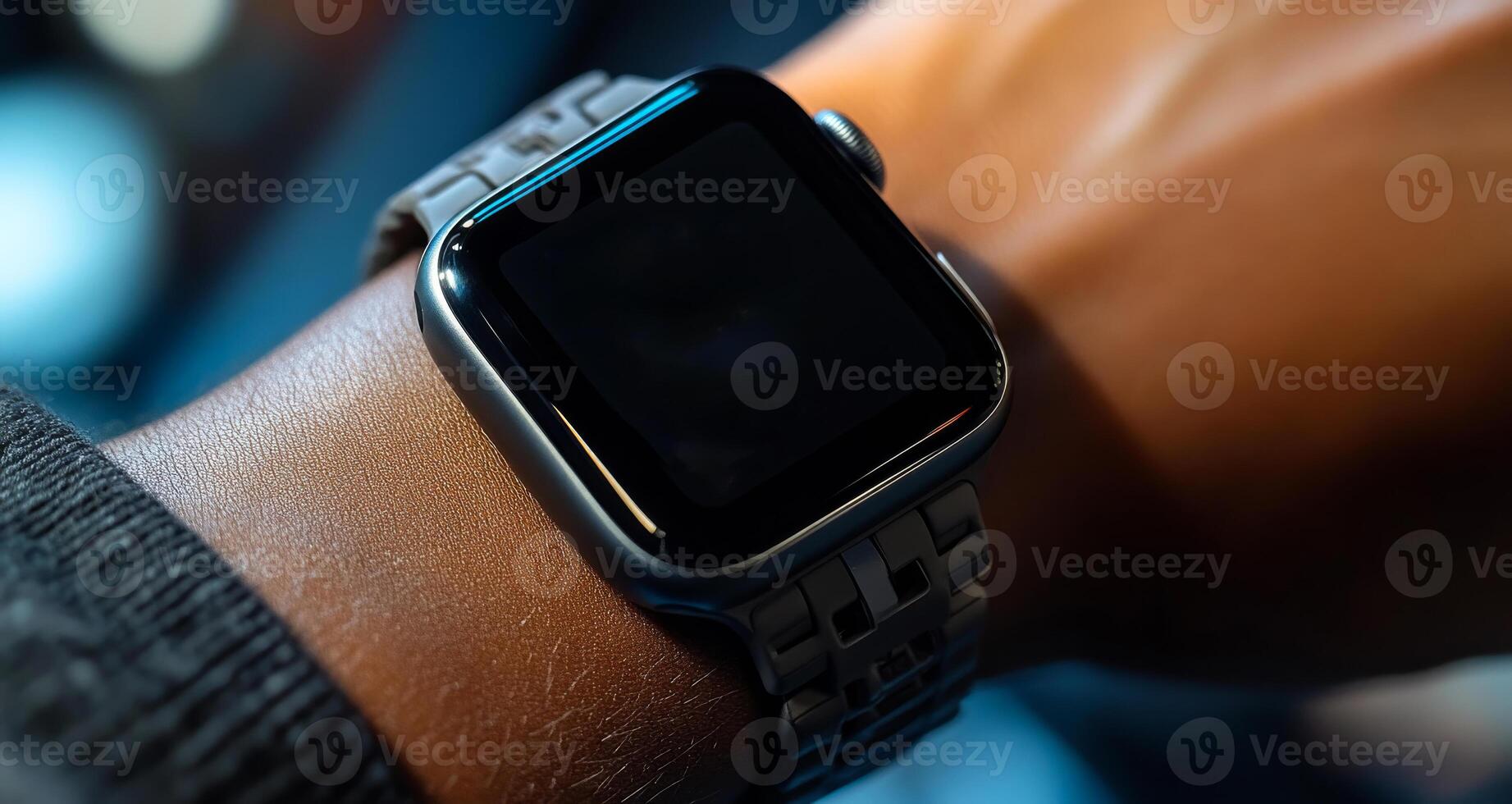 A person wearing a watch with a black face and a silver band. The watch is not showing the time photo
