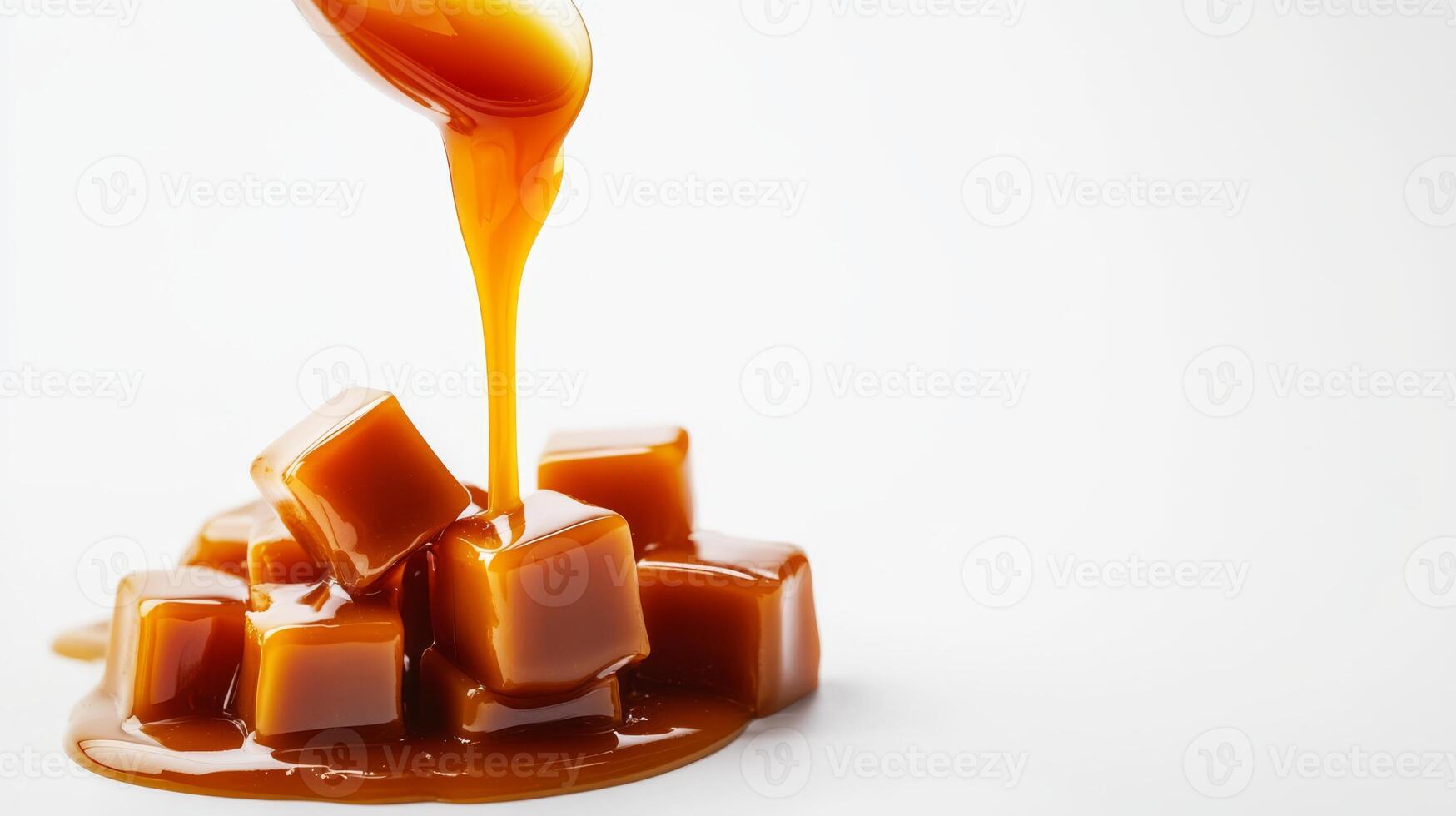 Indulgent caramel sauce is cascading down over smooth, rich caramel cubes, creating a delightful dessert experience photo