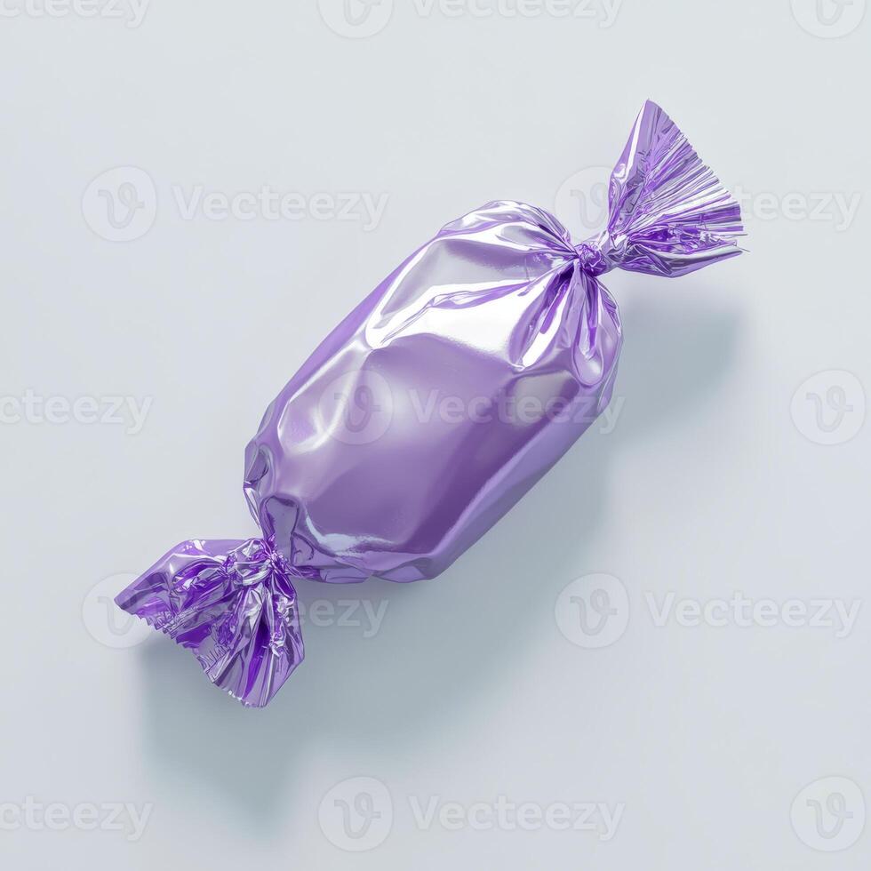 A shiny purple candy that is beautifully wrapped in decorative foil, presenting a delightful and delicious treat that is perfect for any type of celebration or special occasion that comes to mind photo