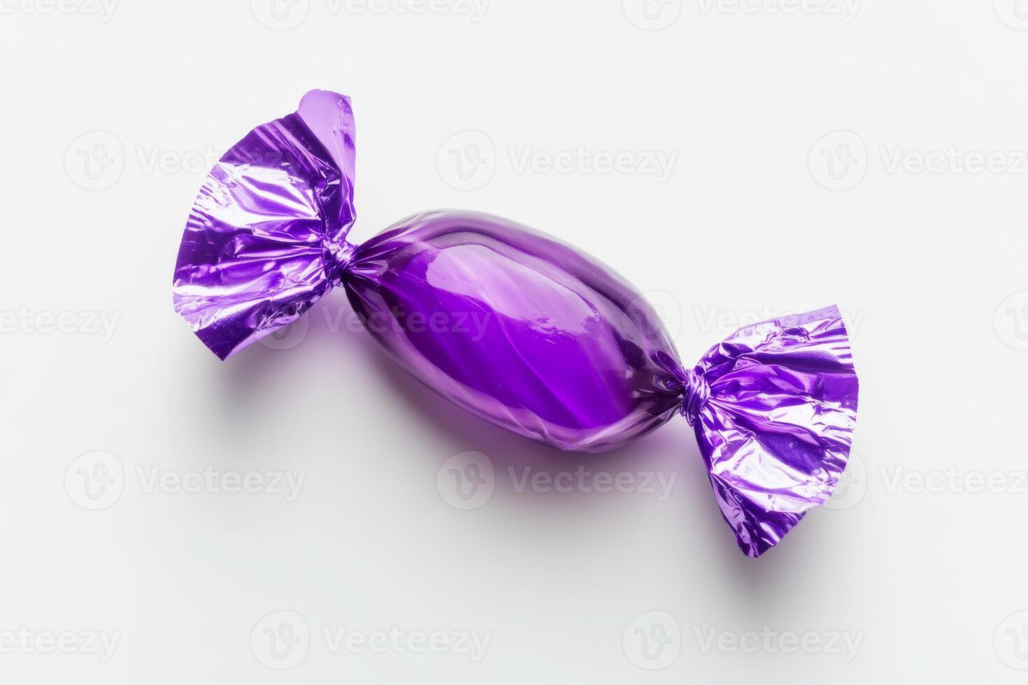 A delightful, transparent purple candy, elegantly wrapped in shiny foil. This treat is absolutely perfect for satisfying sweet cravings during festive occasions, parties, and all joyous celebrations photo