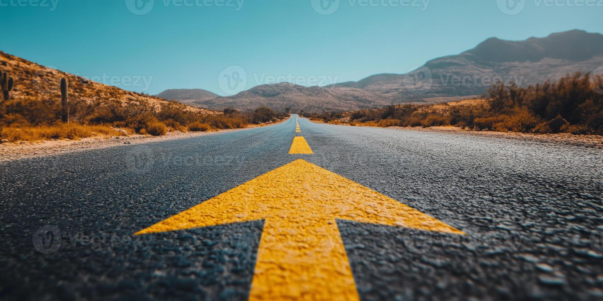 An expansive asphalt road with a vivid yellow arrow symbolizes guidance and forward motion, illustrating a journey toward achievement and exploring endless future possibilities ahead photo