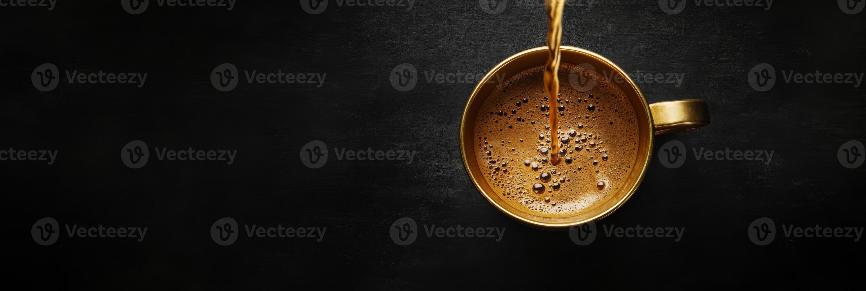 A stunning topdown view shows rich coffee poured into a golden cup, contrasted against a sleek black background. Ideal for coffee lovers and those who appreciate coffee art and aesthetics photo