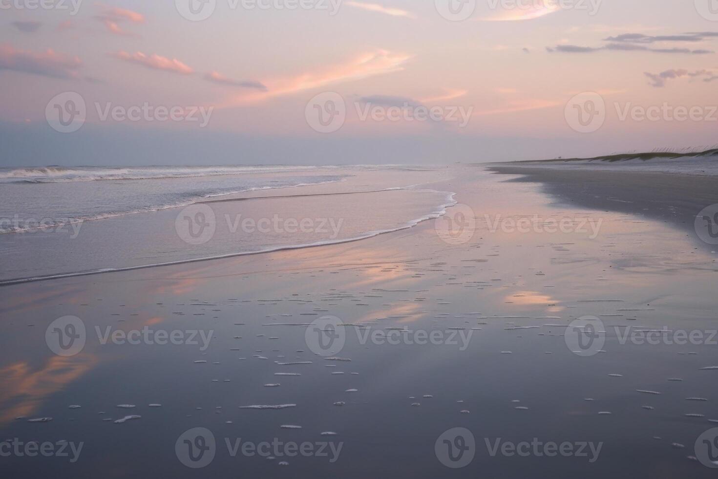 Pastel reflections on calm beach waves at twilight photo