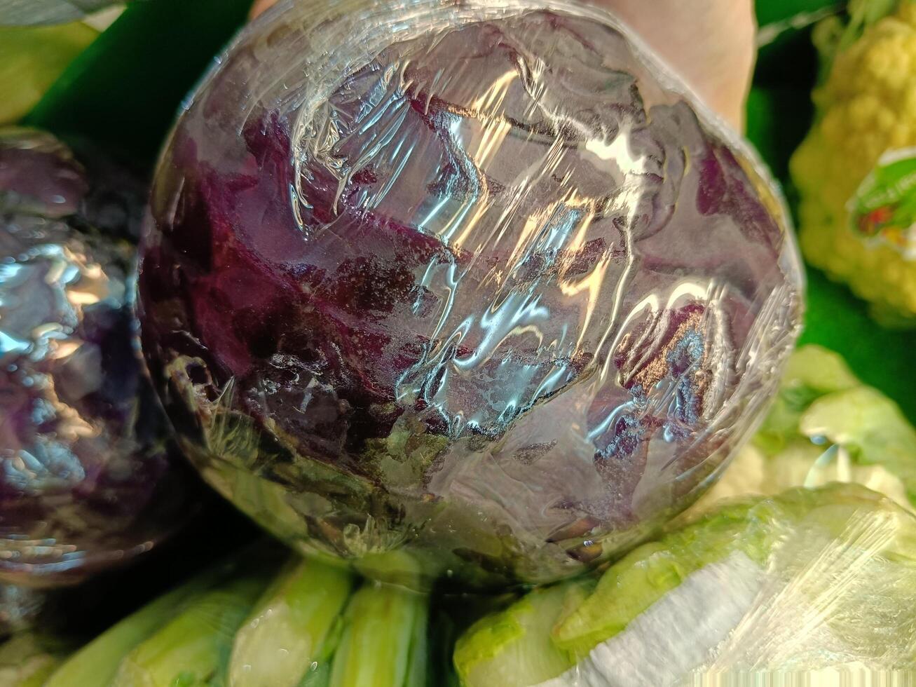 Closeup of fresh purple cabbage in display case photo