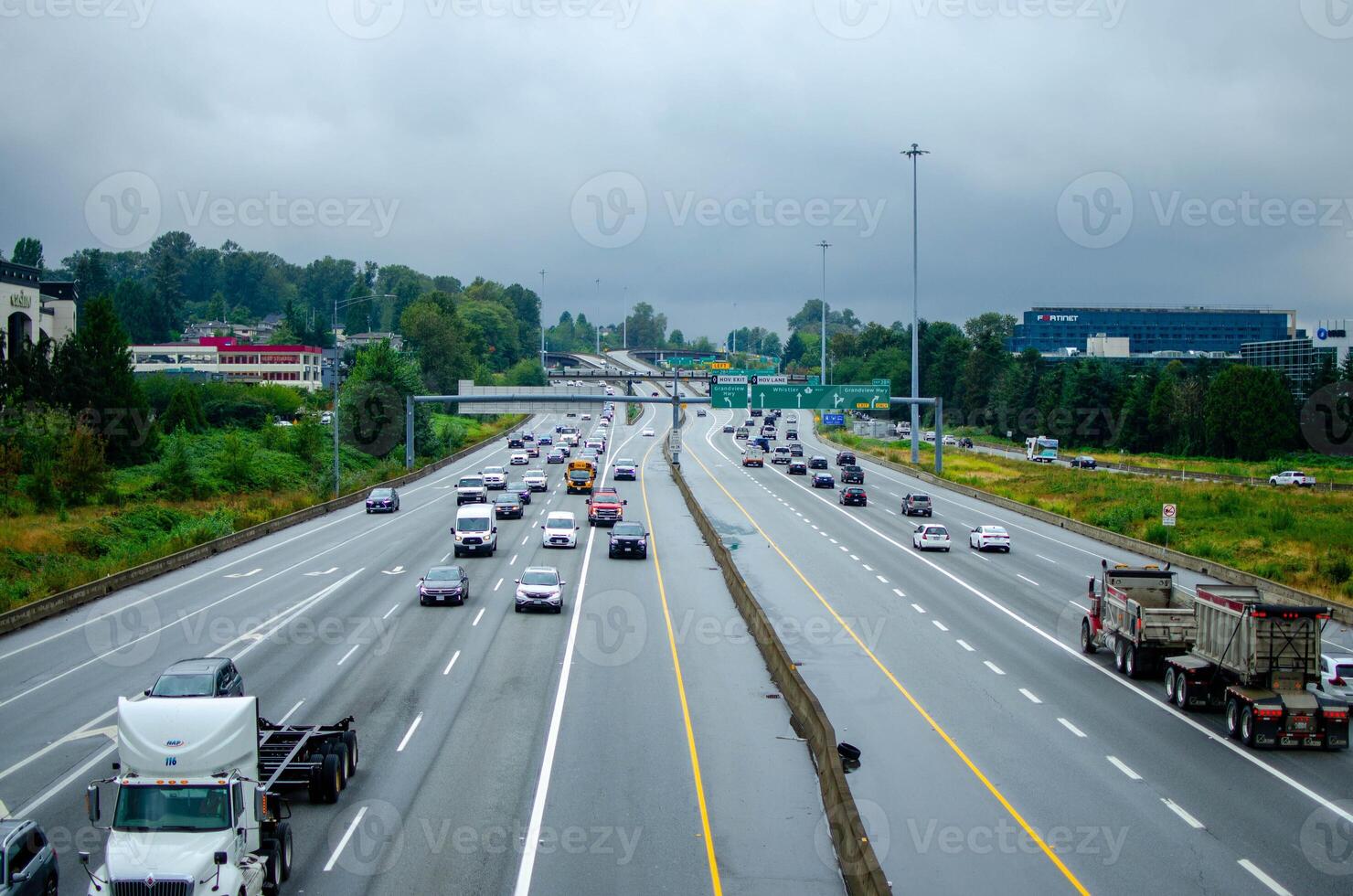 Busy Highway Traffic on Overcast Day with Urban Surroundings photo