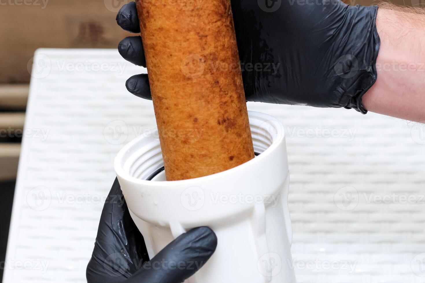 The plumber is changing the replaceable dirty used aqua filter. Replaceable dirty filters for filtration of reverse osmosis water photo