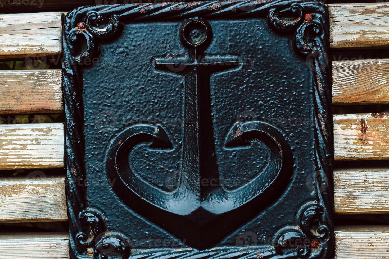 bronze sign as anchors on a wooden bench. photo