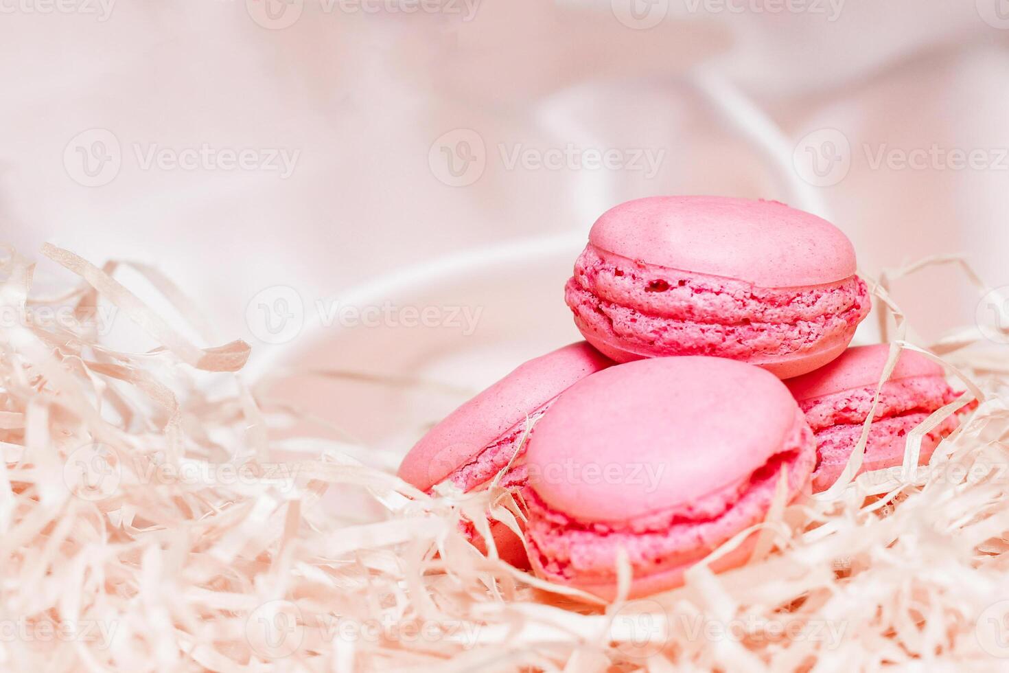 French pink macaroon cookies on silk tablecloth photo
