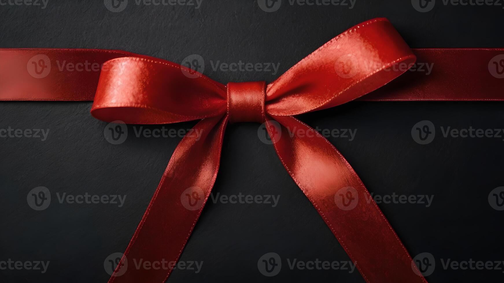 Elegant Red Ribbon Bow on Black Background with Copy Space for Christmas Wishes photo