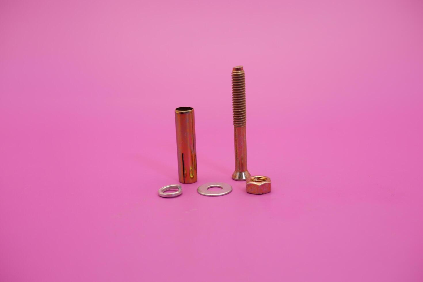 dynabolt isolated on purple background. bolt consisting of washer, sleeve, nut, and threaded bolt. bolt commonly used to fasten objects to concrete. photo