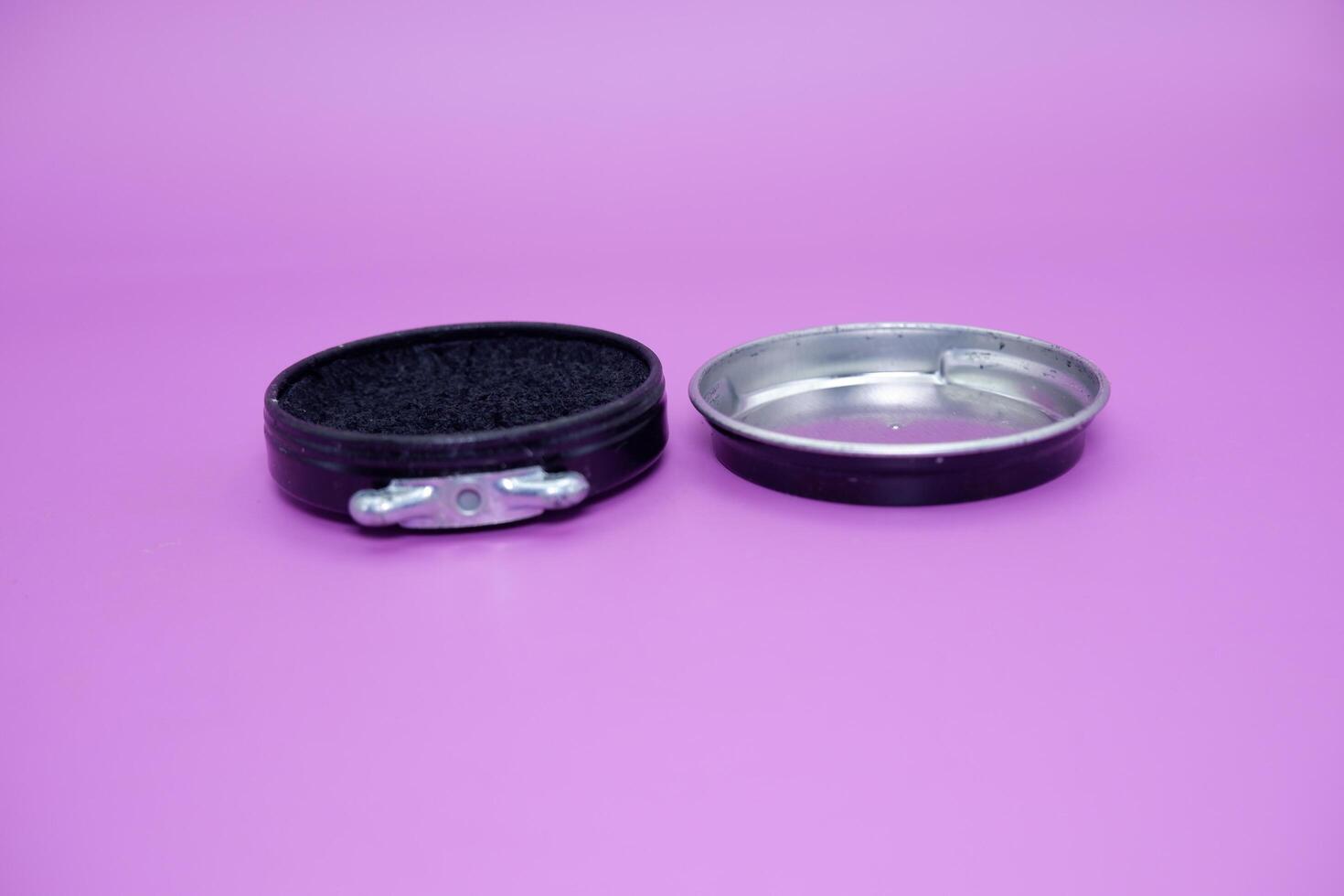 black shoe polish isolated purple background. shoe polish that is usually used with a brush to polish shoes photo