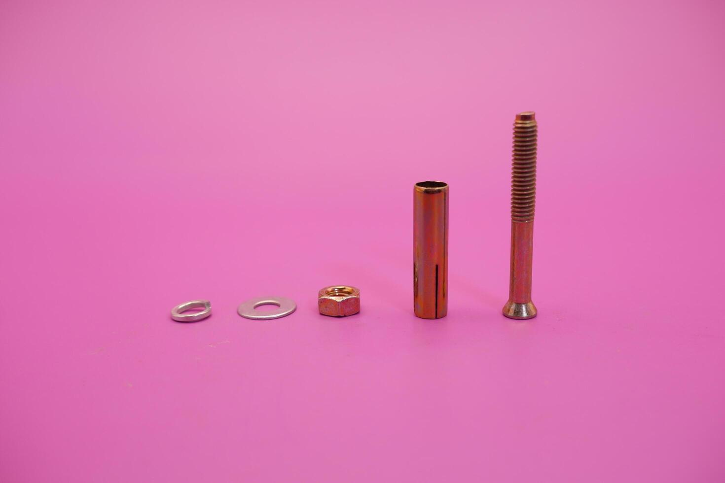 dynabolt isolated on purple background. bolt consisting of washer, sleeve, nut, and threaded bolt. bolt commonly used to fasten objects to concrete. photo