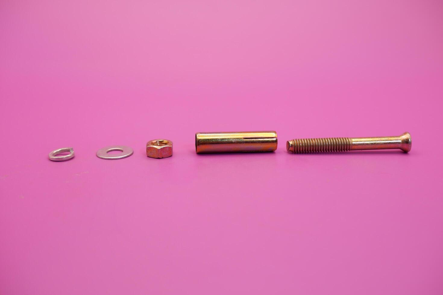 dynabolt isolated on purple background. bolt consisting of washer, sleeve, nut, and threaded bolt. bolt commonly used to fasten objects to concrete. photo