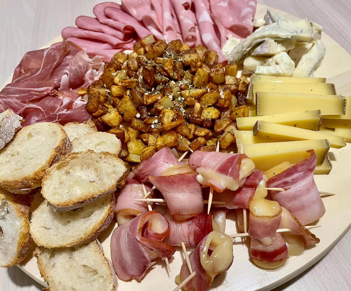 Appetizer platter with cheese and pork cold cuts photo