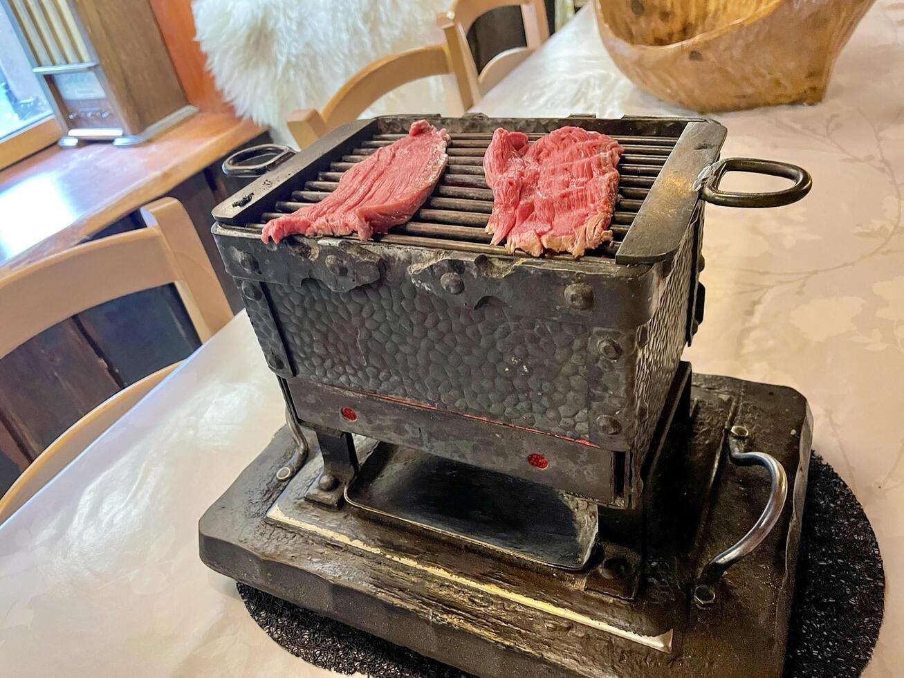 Brasero Grill with beef in an old rustic restaurant photo