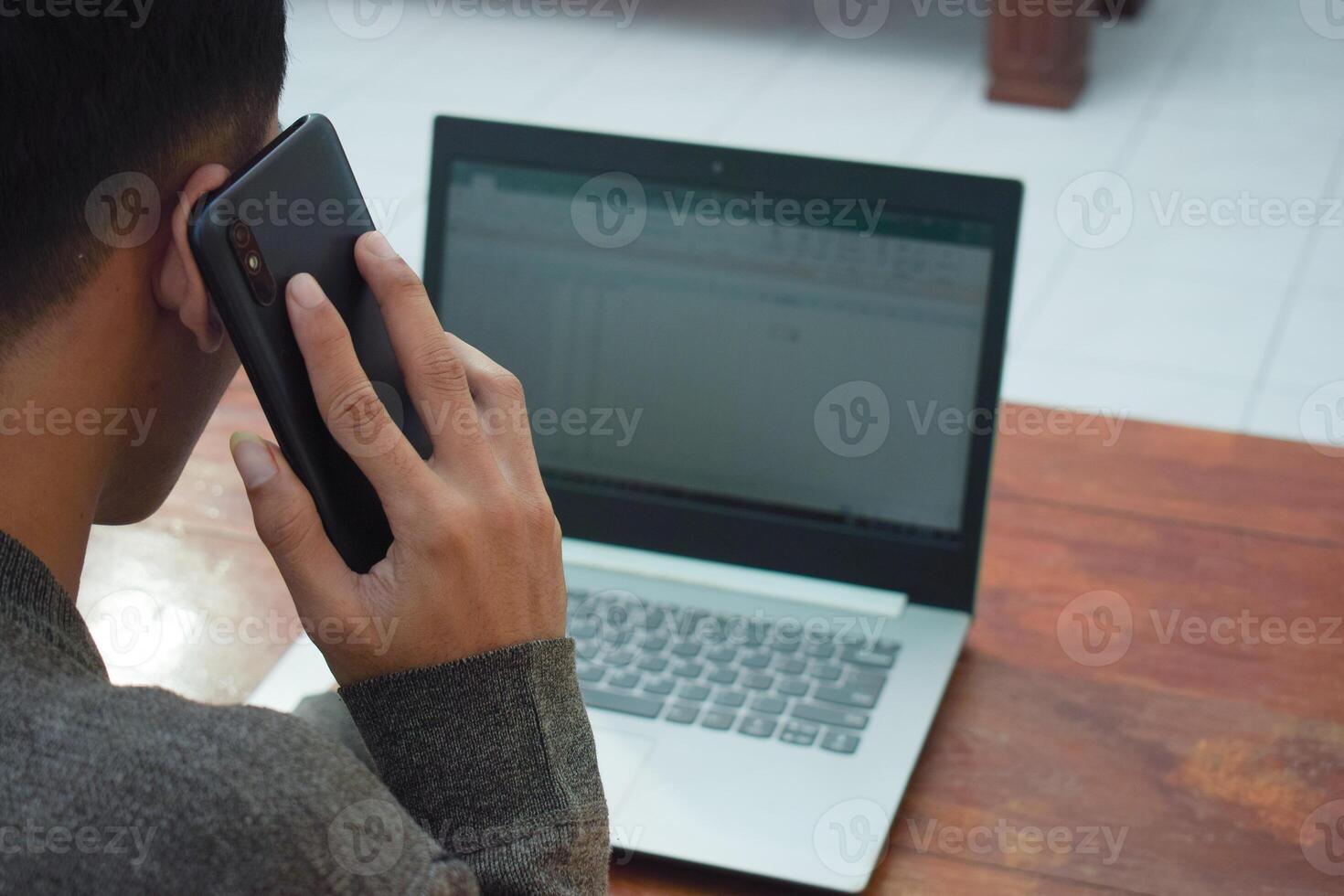 Close up top view employee working remote at home in living room, typing laptop due job deadline photo