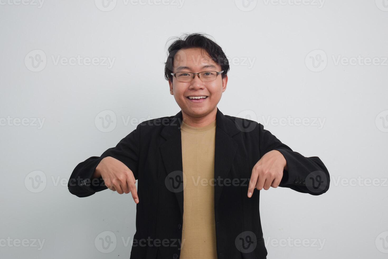 Joyful asian businessman with suit and casual shirt showing product or pointing gesture in isolated white background photo