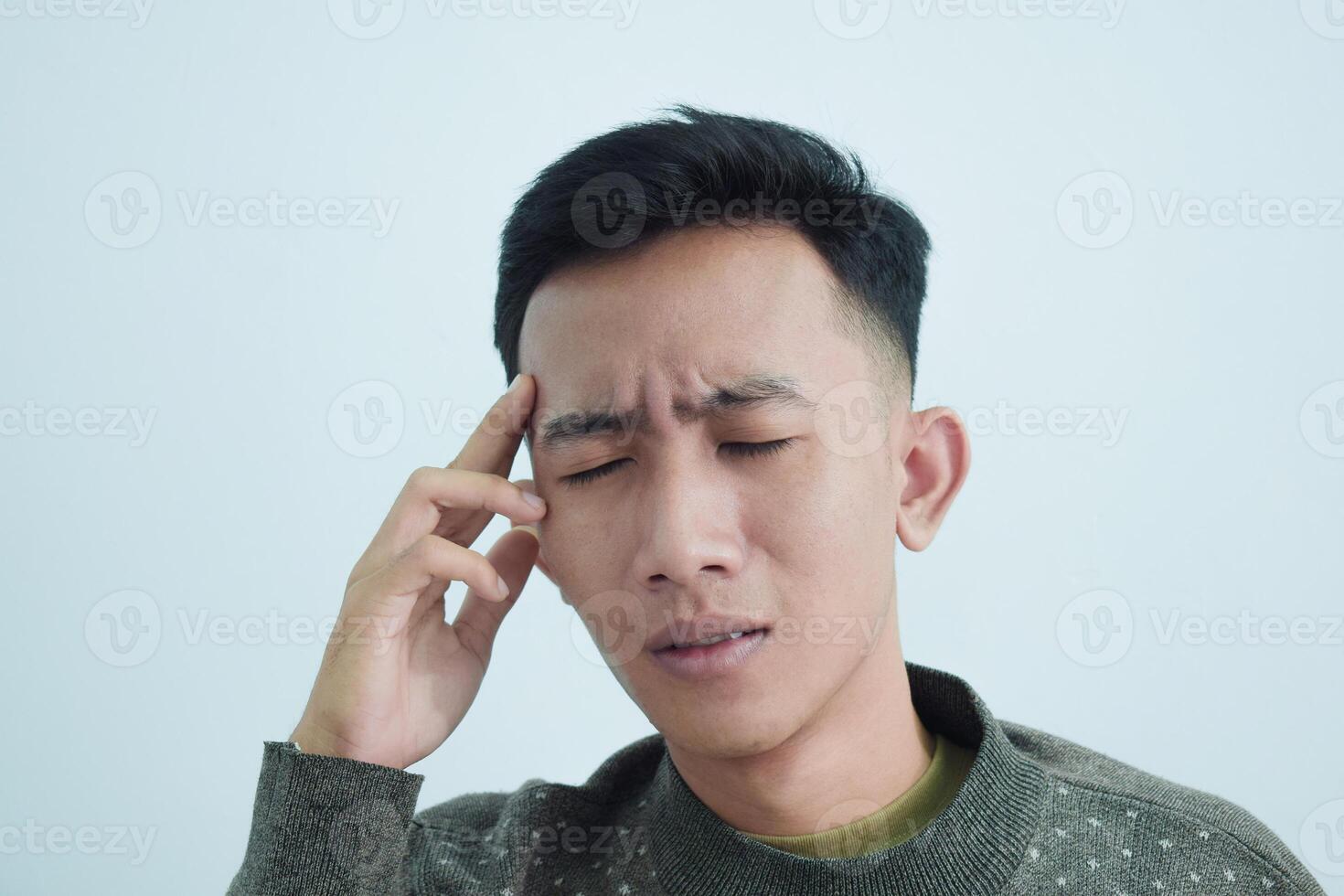 Close up asian young man touching head feel headache and pain isolated on white background photo