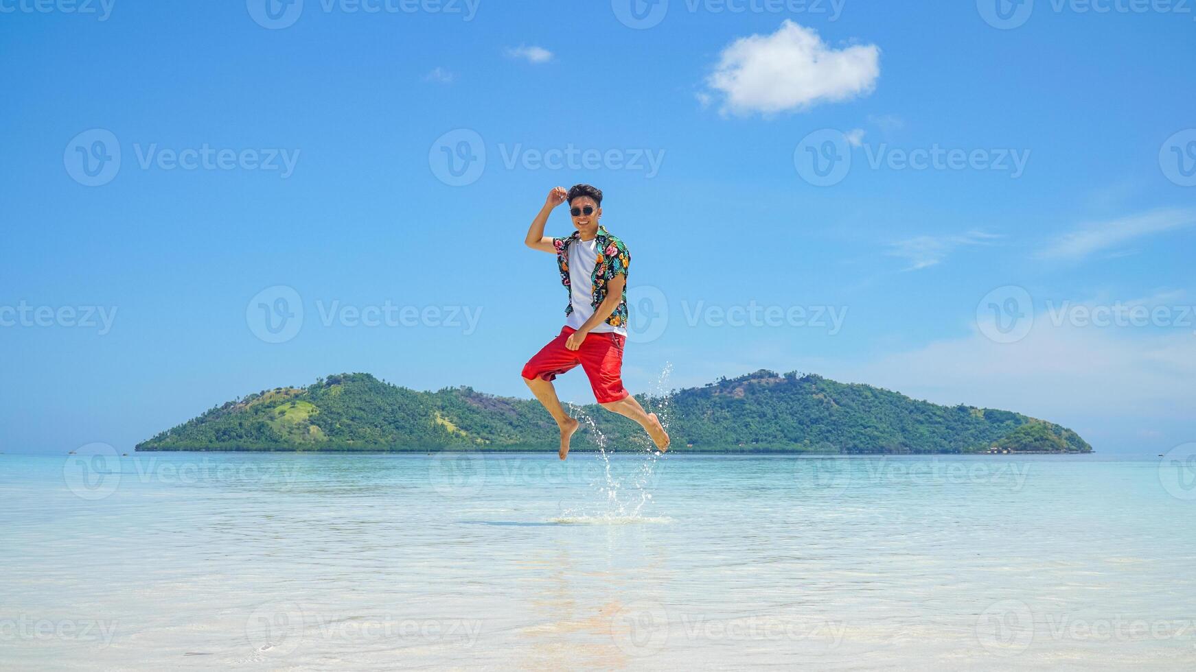 Man Jumping in Tropical Paradise photo