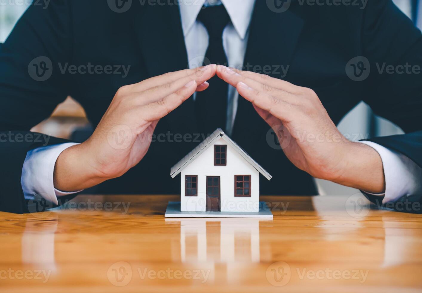 Hand protecting the icon house - the concept of insurance photo