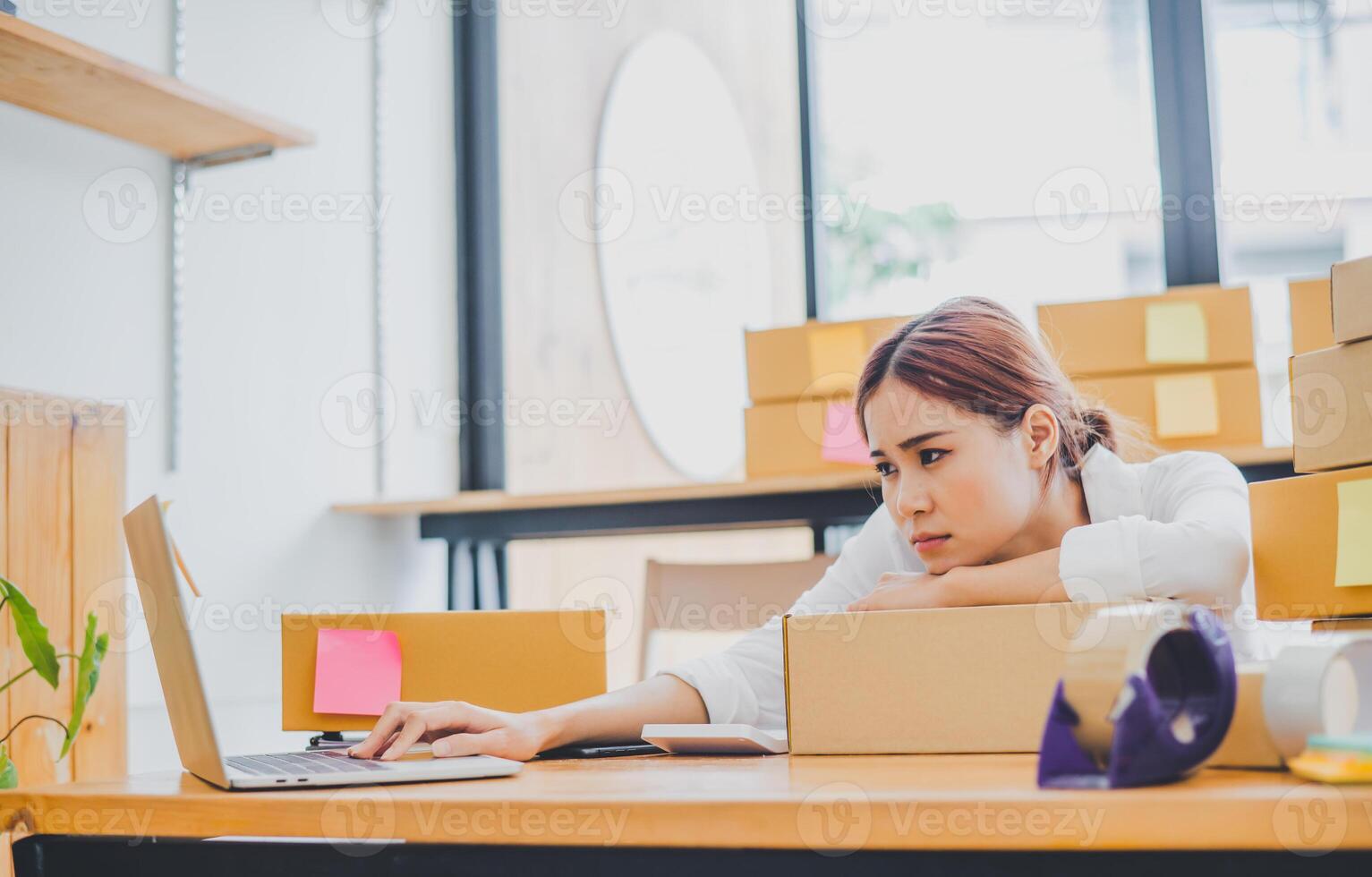 Online small business owners are sad and bored waiting for orders that haven't yet arrived. Online Retailers - Online Shopping photo