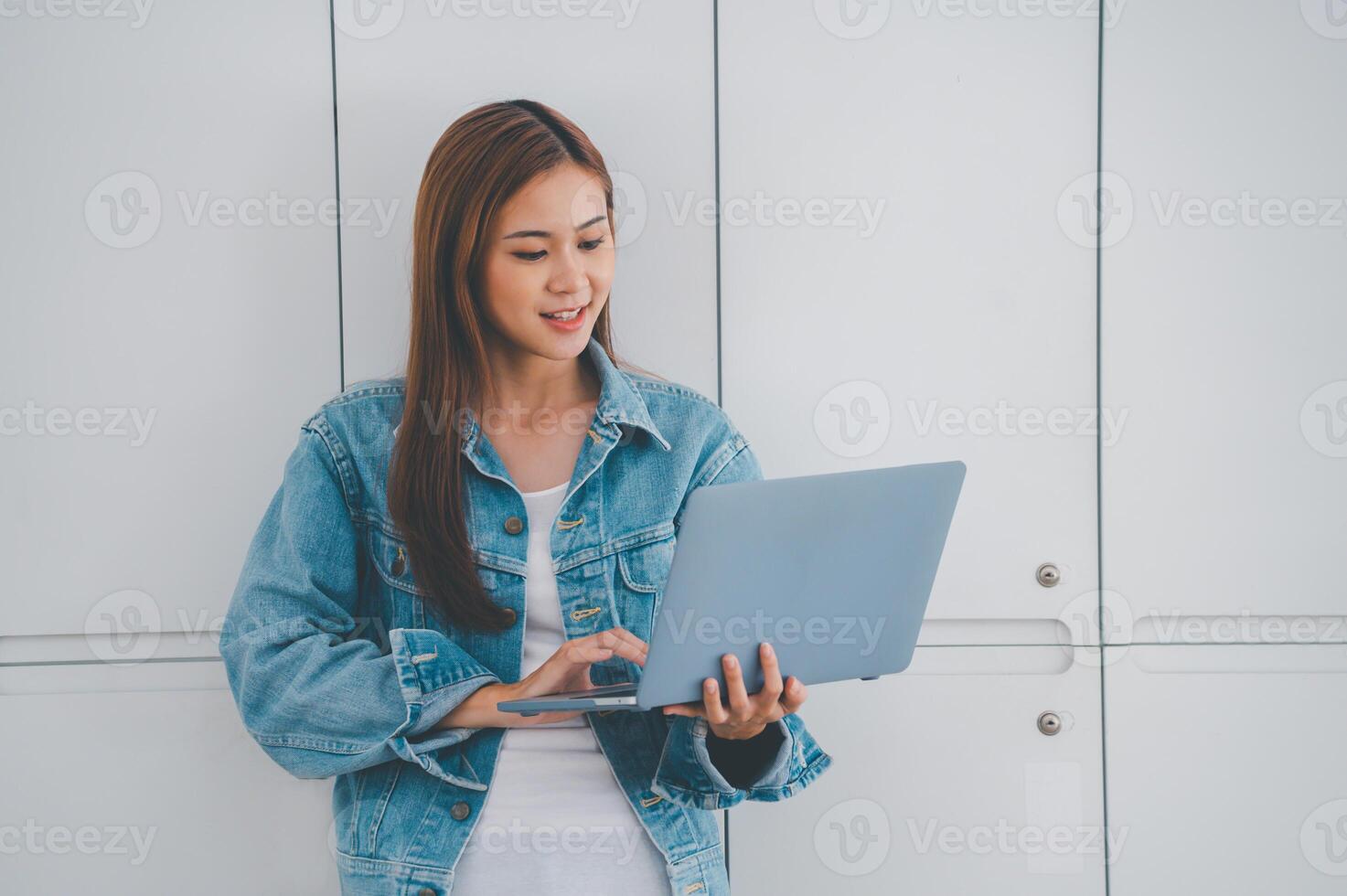 young student wearing small talk studies online, distance learning, and keeps up to date on the global coronavirus pandemic photo