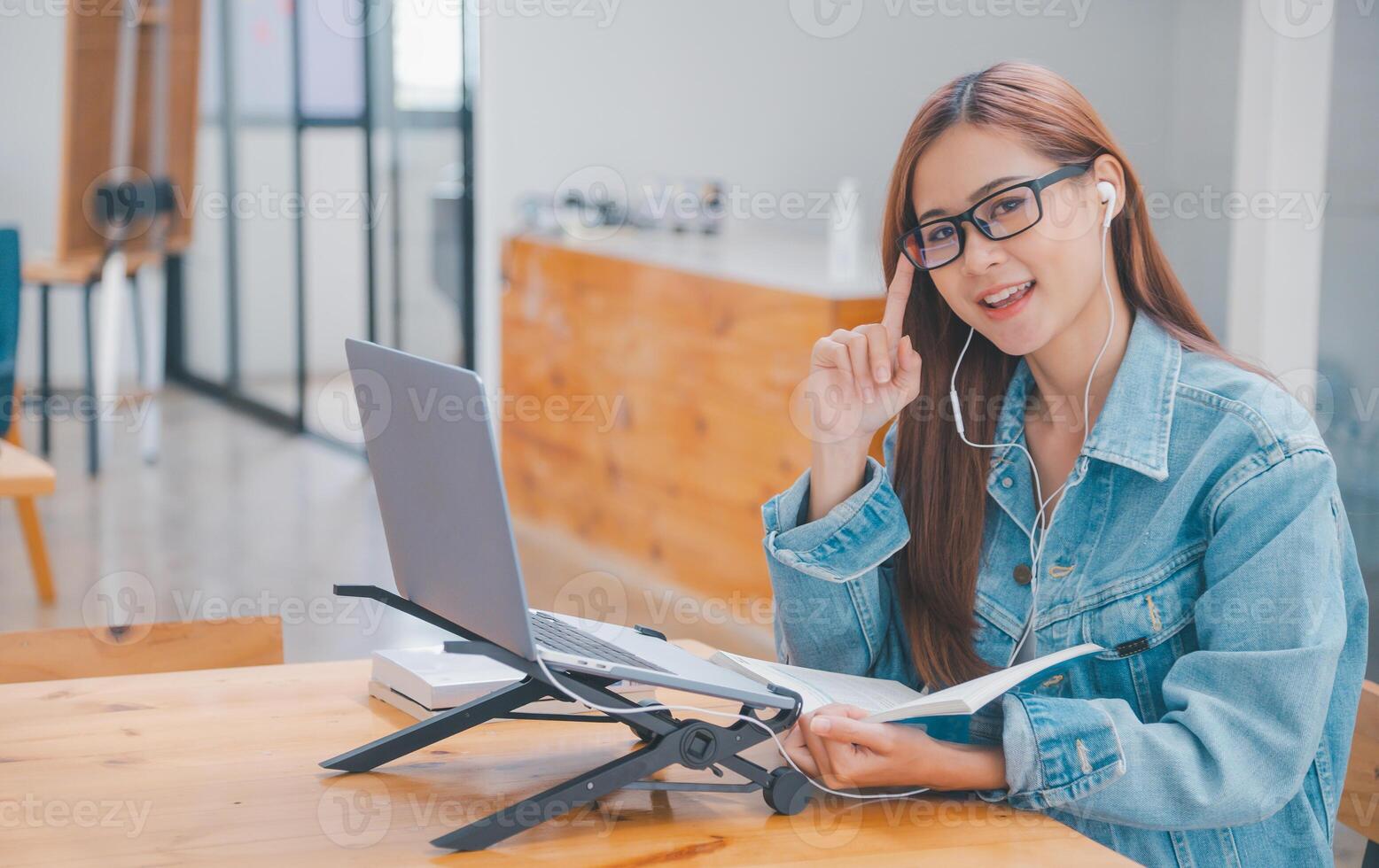 young student wearing small talk studies online, distance learning, and keeps up to date on the global coronavirus pandemic photo