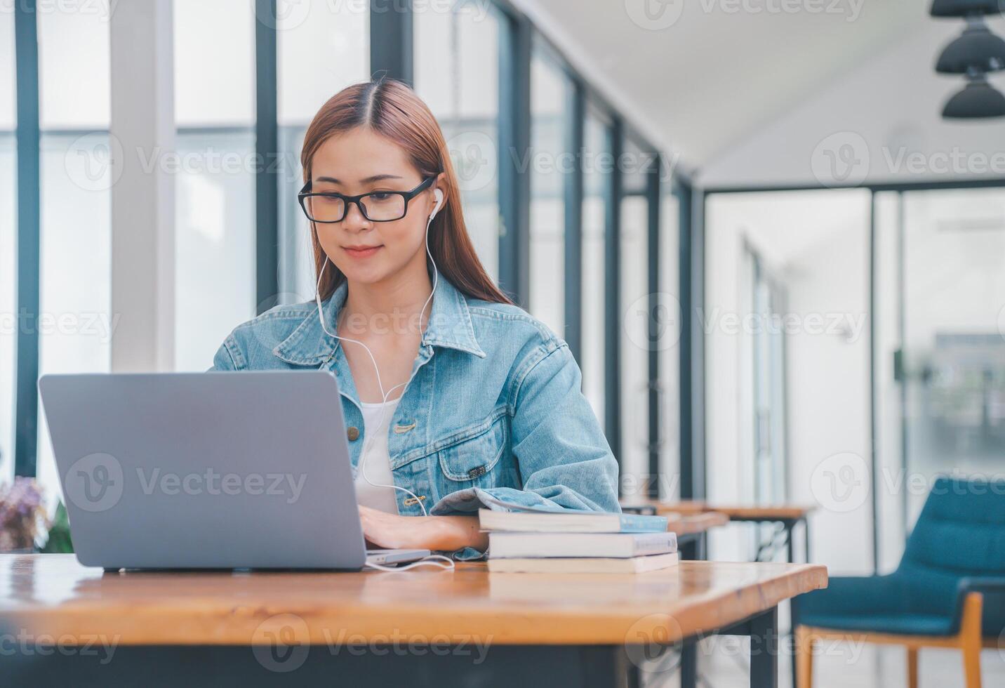 young student wearing small talk studies online, distance learning, and keeps up to date on the global coronavirus pandemic photo