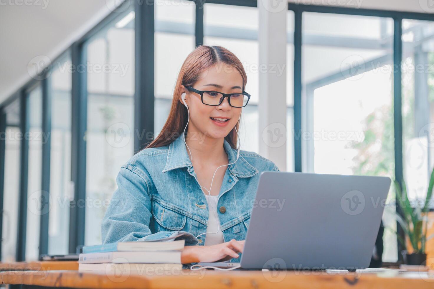 young student wearing small talk studies online, distance learning, and keeps up to date on the global coronavirus pandemic photo