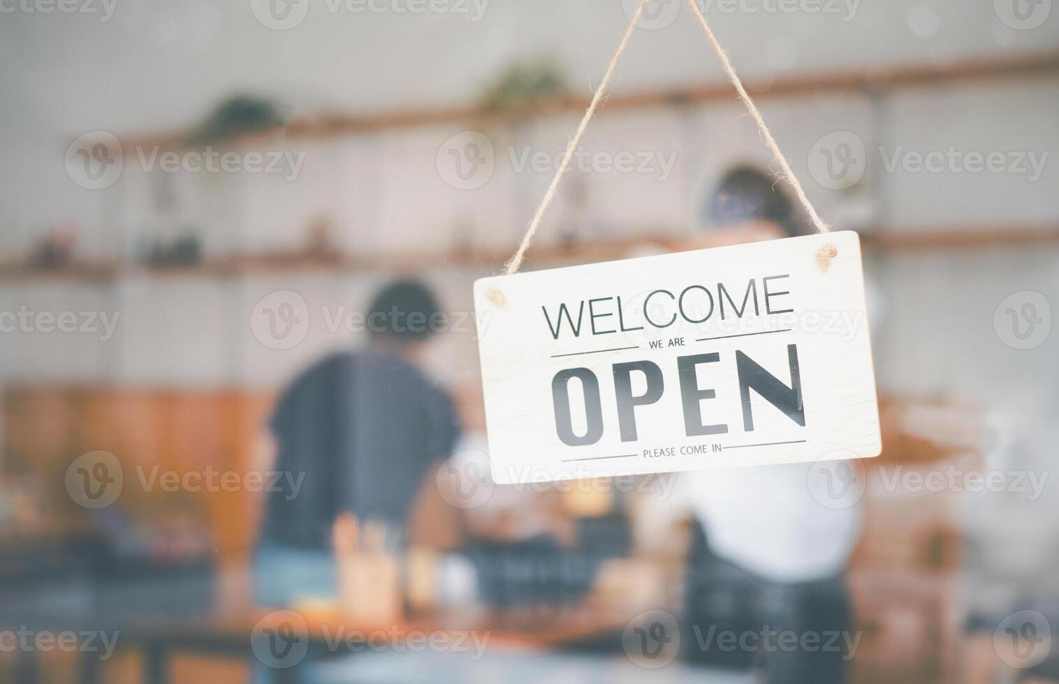 wooden Open sign hangs at the cafe's or restaurant's entrance. photo