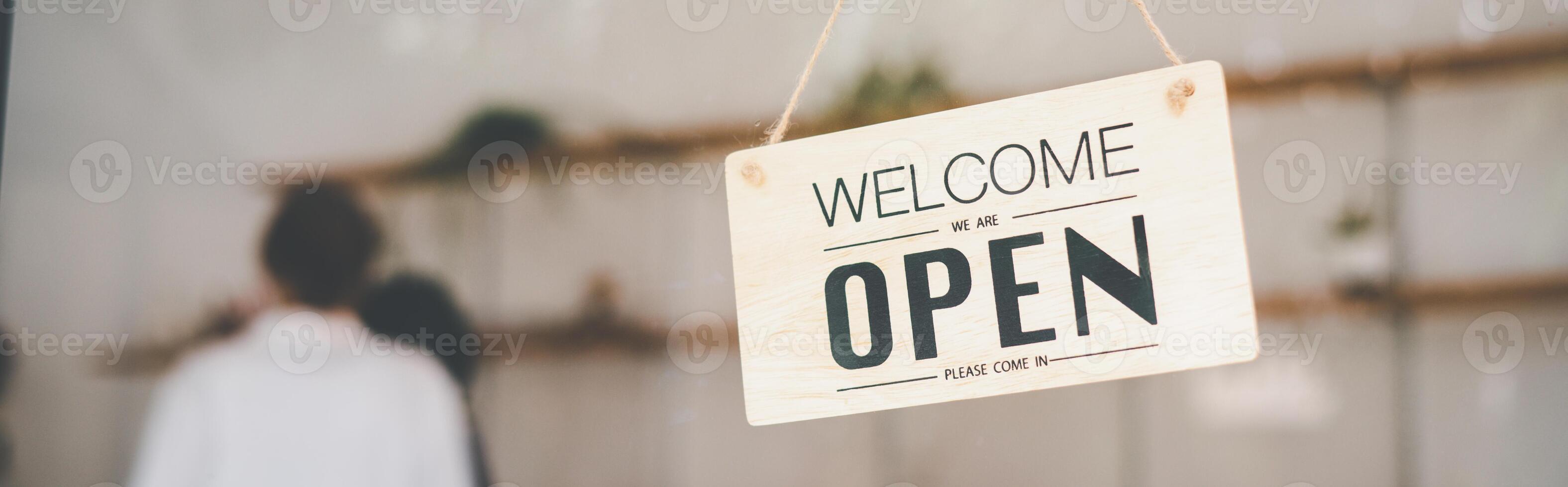 wooden Open sign hangs at the cafe's or restaurant's entrance. photo