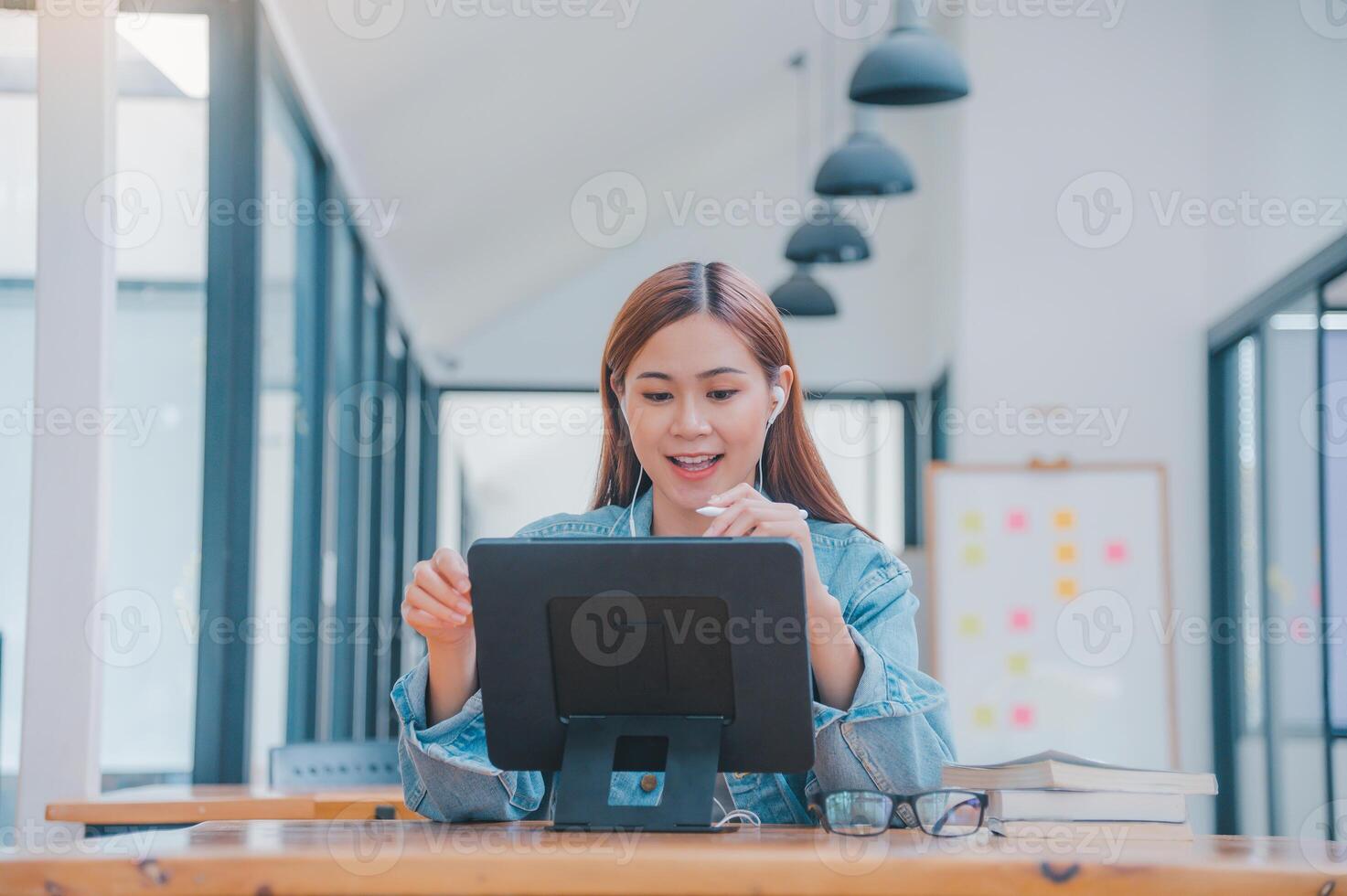 young student wearing small talk studies online, distance learning, and keeps up to date on the global coronavirus pandemic photo