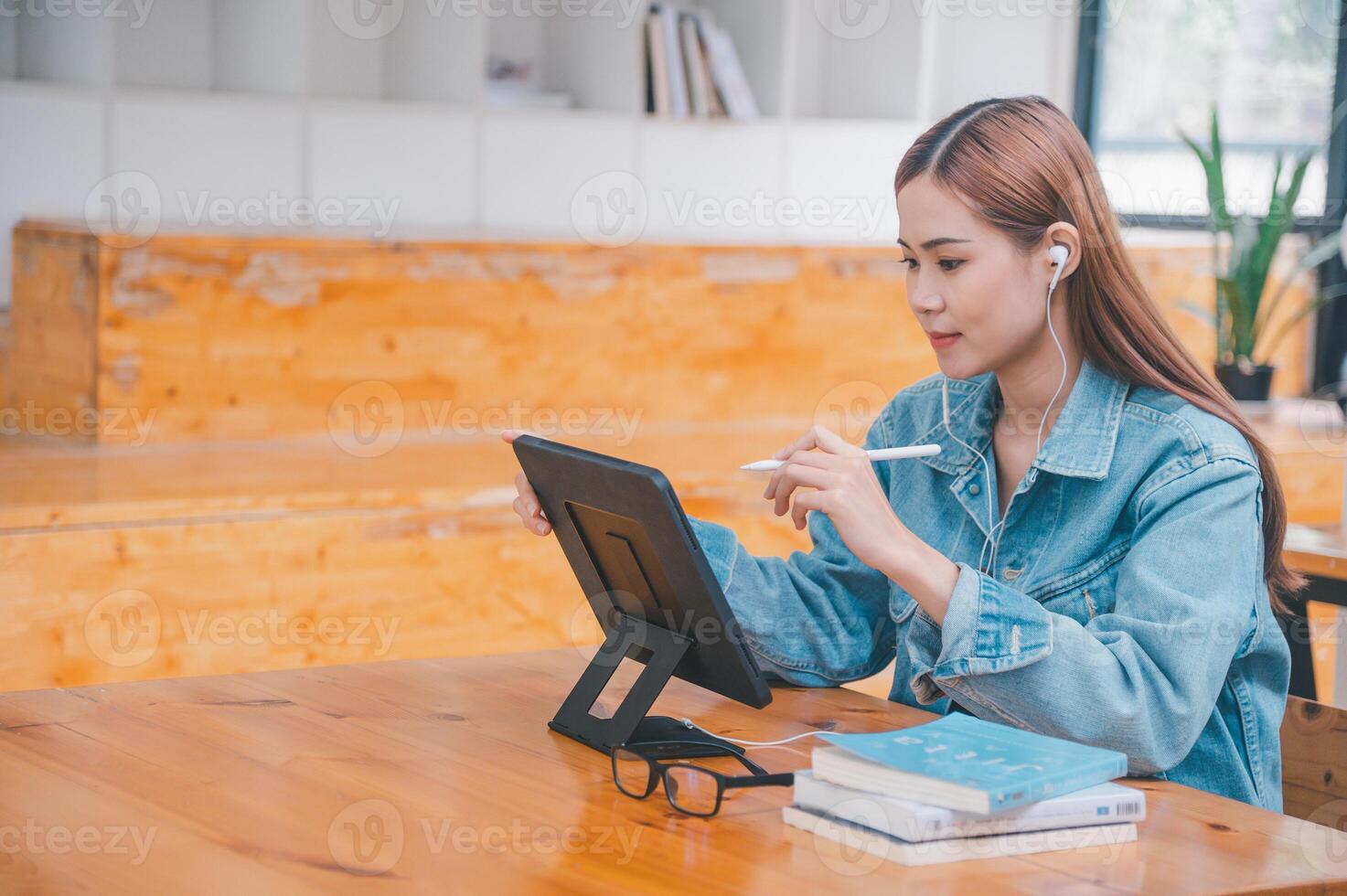 young student wearing small talk studies online, distance learning, and keeps up to date on the global coronavirus pandemic photo
