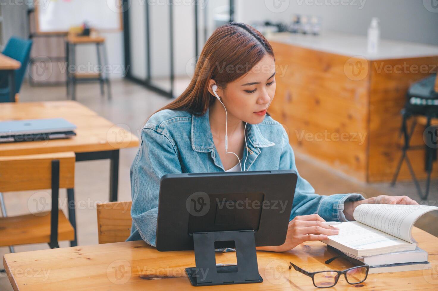 young student wearing small talk studies online, distance learning, and keeps up to date on the global coronavirus pandemic photo