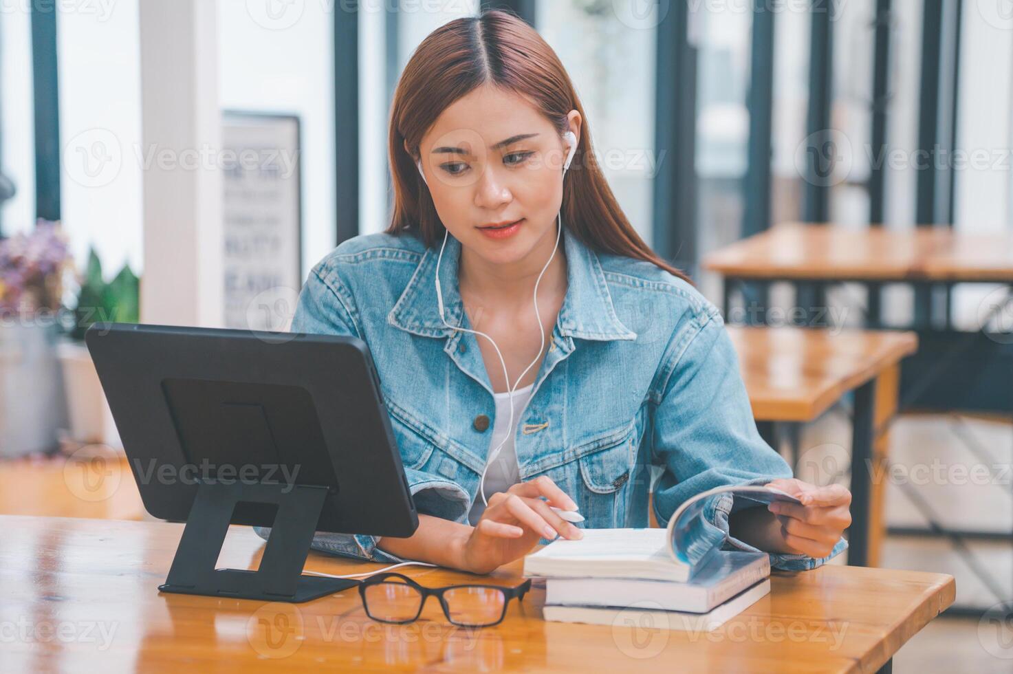 young student wearing small talk studies online, distance learning, and keeps up to date on the global coronavirus pandemic photo
