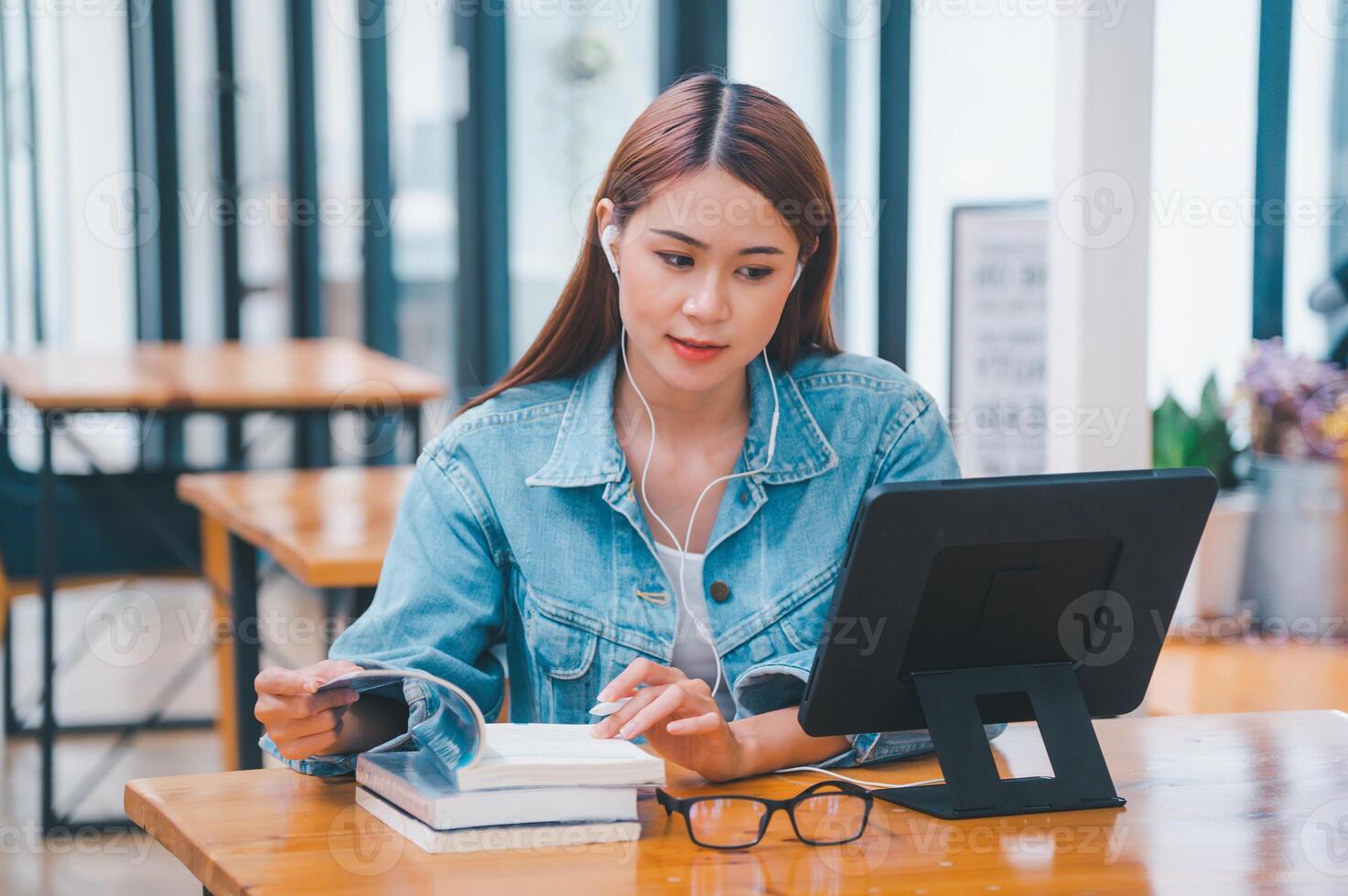 young student wearing small talk studies online, distance learning, and keeps up to date on the global coronavirus pandemic photo