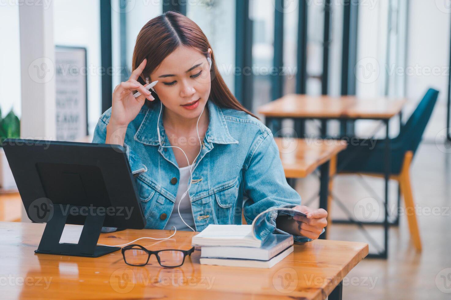young student wearing small talk studies online, distance learning, and keeps up to date on the global coronavirus pandemic photo
