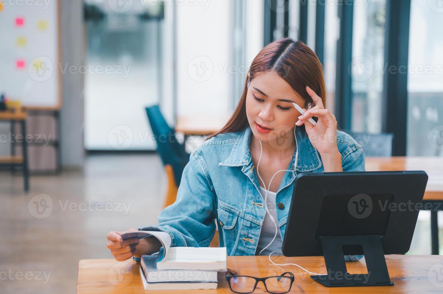 young student wearing small talk studies online, distance learning, and keeps up to date on the global coronavirus pandemic photo