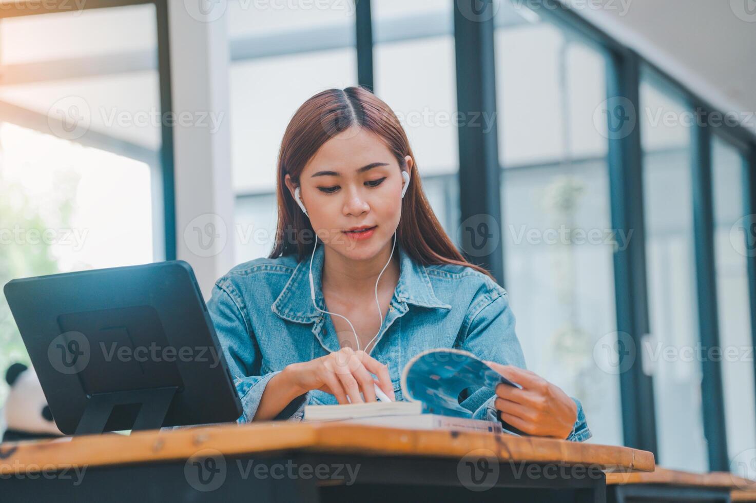young student wearing small talk studies online, distance learning, and keeps up to date on the global coronavirus pandemic photo