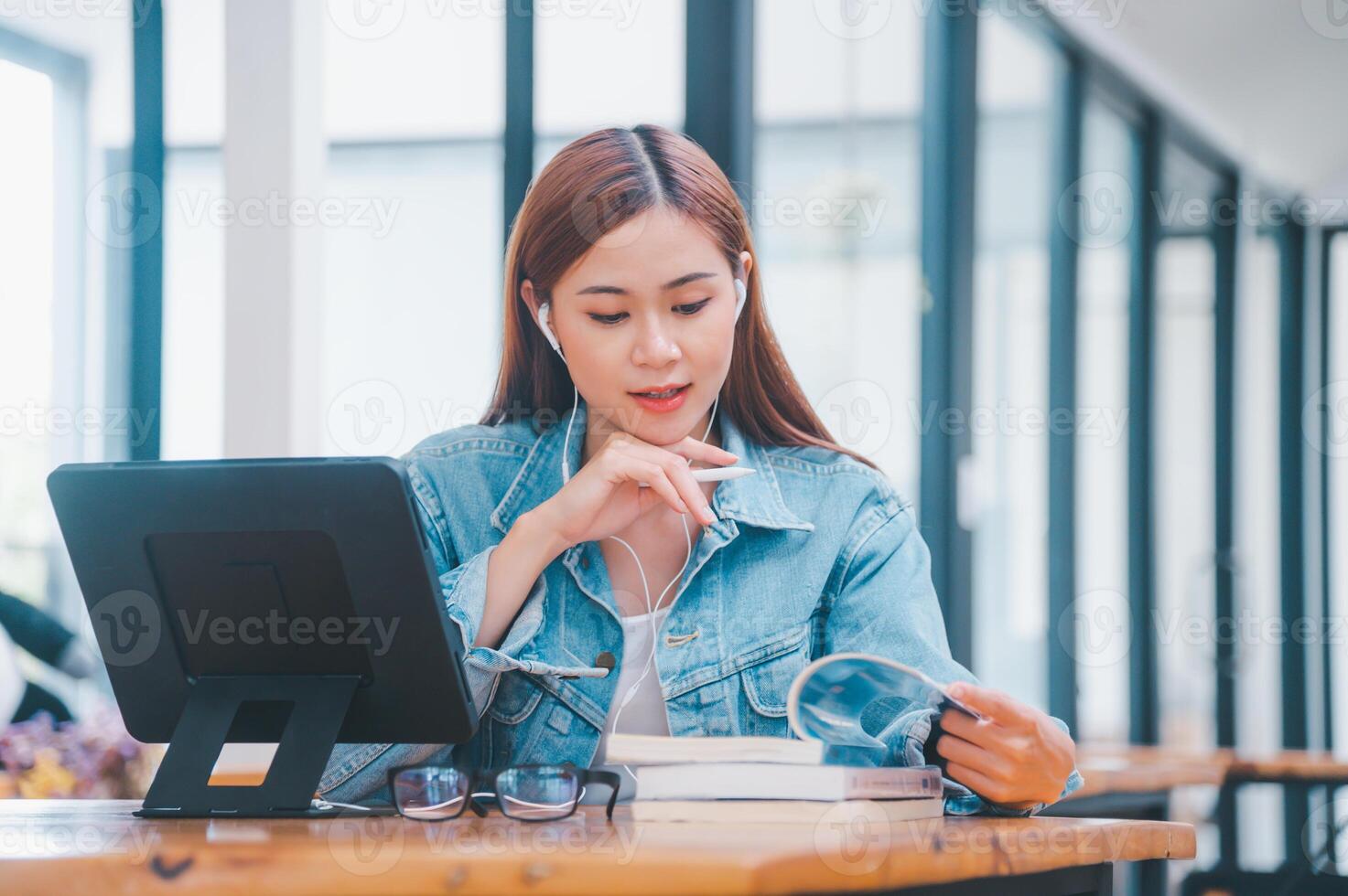 young student wearing small talk studies online, distance learning, and keeps up to date on the global coronavirus pandemic photo