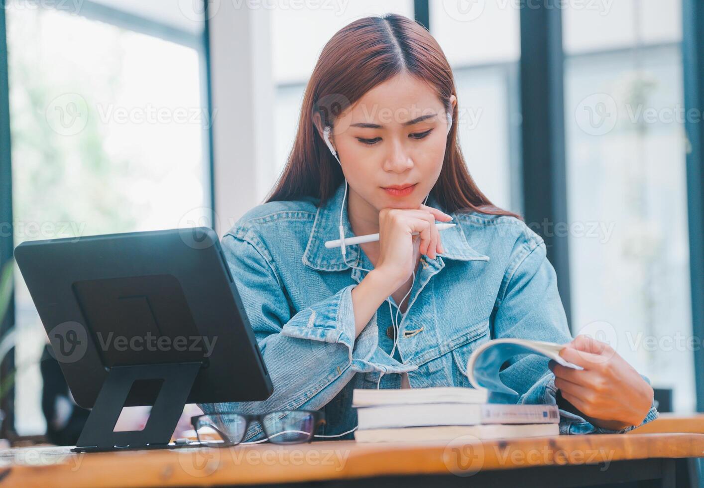 young student wearing small talk studies online, distance learning, and keeps up to date on the global coronavirus pandemic photo