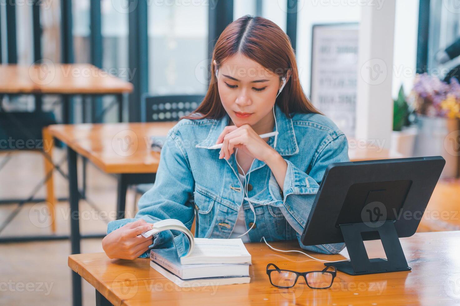young student wearing small talk studies online, distance learning, and keeps up to date on the global coronavirus pandemic photo