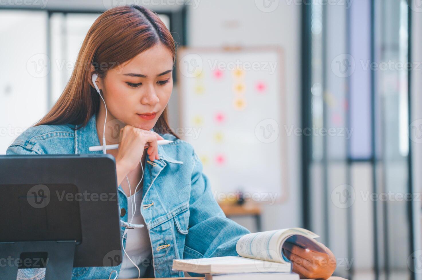 young student wearing small talk studies online, distance learning, and keeps up to date on the global coronavirus pandemic photo