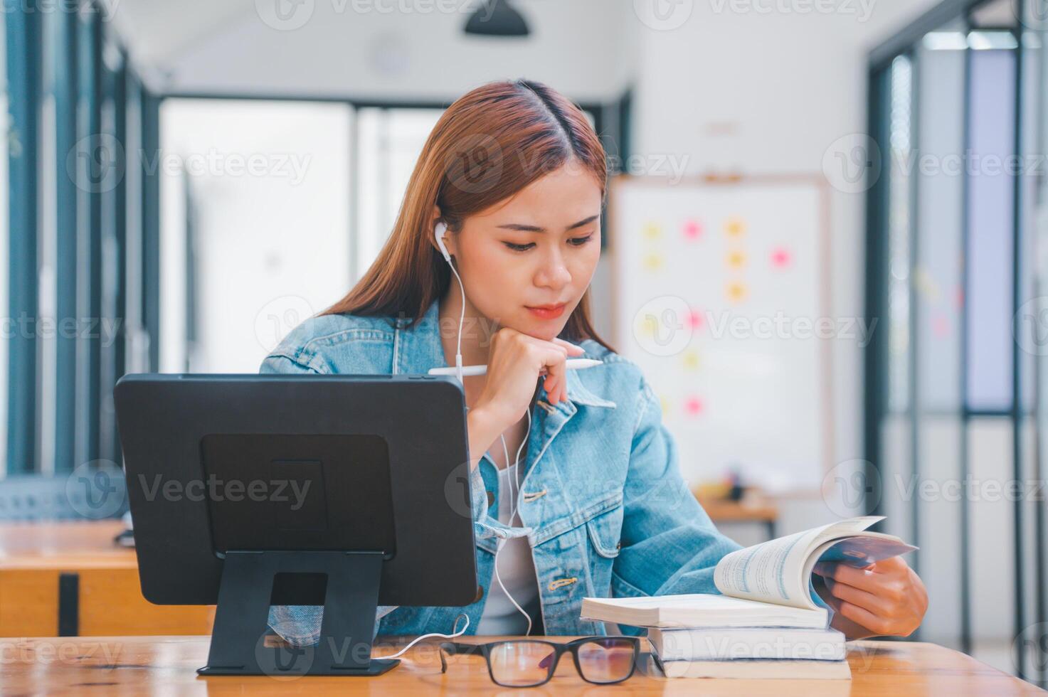 young student wearing small talk studies online, distance learning, and keeps up to date on the global coronavirus pandemic photo